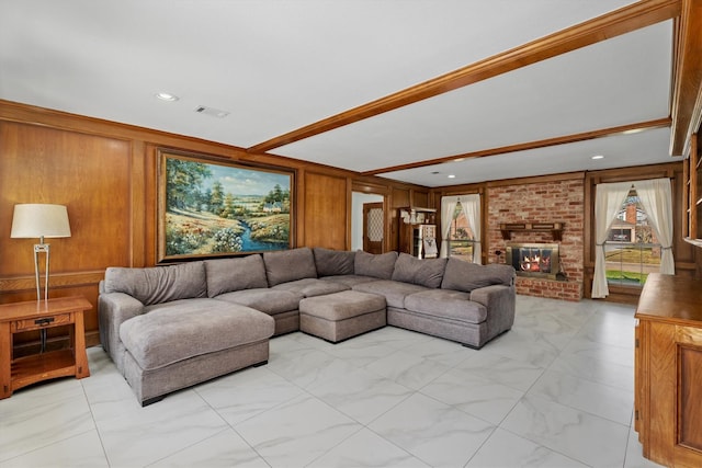 living room with a fireplace and wooden walls