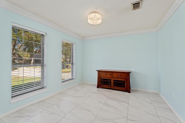 unfurnished room featuring ornamental molding and an inviting chandelier