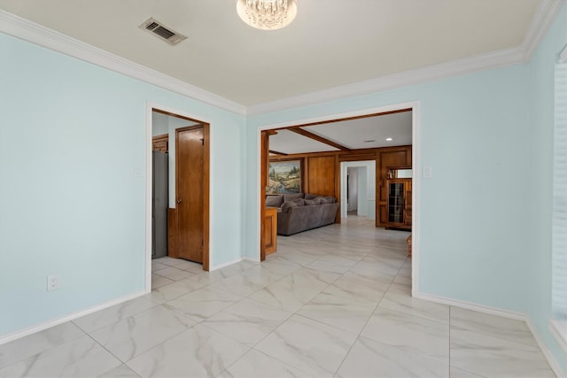 empty room featuring a chandelier and crown molding