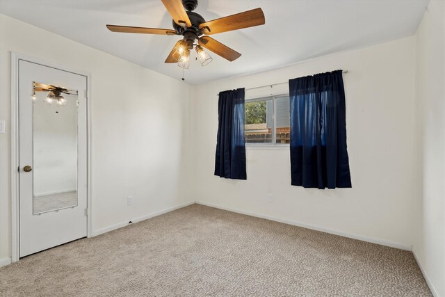 unfurnished room featuring carpet floors and ceiling fan