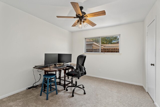 carpeted office space featuring ceiling fan