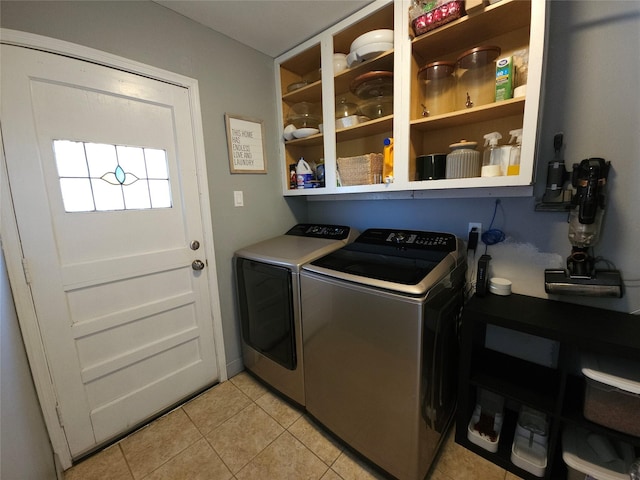 laundry room with light tile patterned flooring and separate washer and dryer