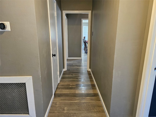 hallway featuring dark hardwood / wood-style flooring