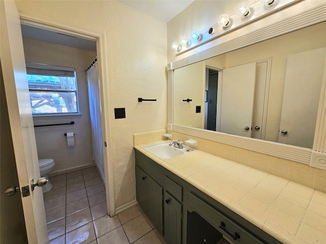 bathroom with vanity, toilet, and tile patterned flooring