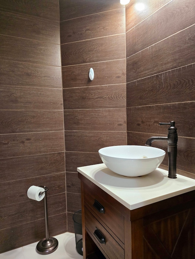 bathroom with wood walls and vanity