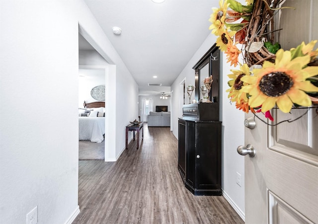 corridor with dark wood-type flooring