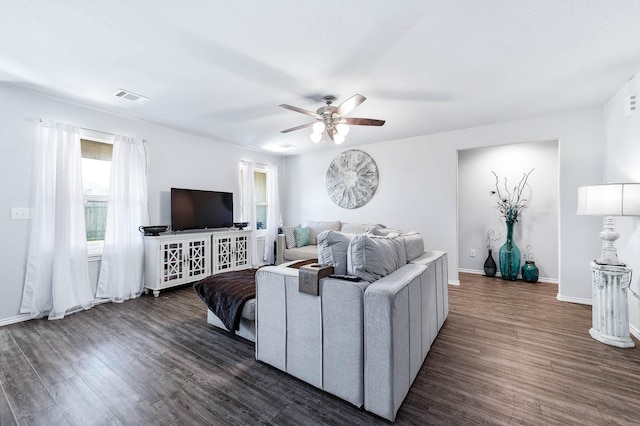 living room featuring ceiling fan and dark hardwood / wood-style floors