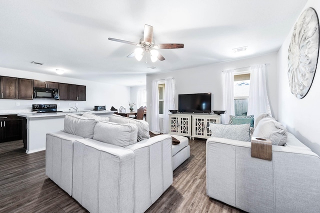 living room featuring ceiling fan and dark hardwood / wood-style flooring