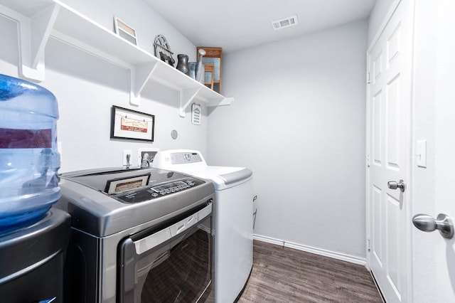 laundry area featuring dark hardwood / wood-style floors and washing machine and clothes dryer