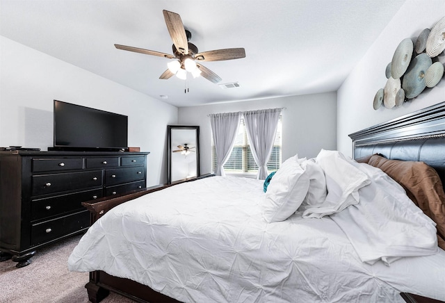 bedroom with ceiling fan and light carpet