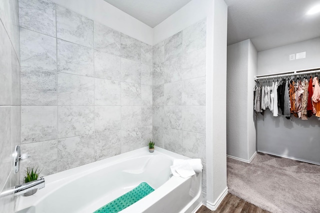 bathroom with a bathing tub and wood-type flooring