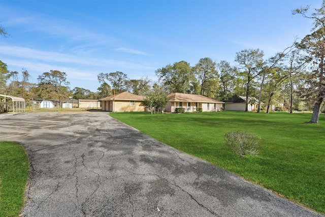 ranch-style home with a front yard