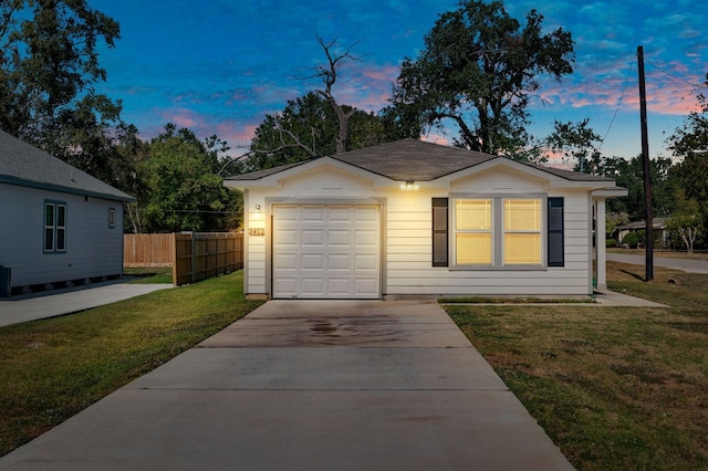 view of front facade featuring a lawn and a garage