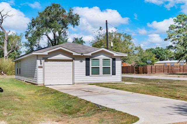 view of front of property with a front yard and a garage