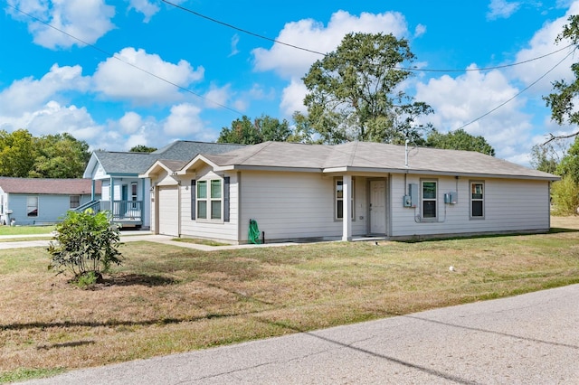 single story home featuring a front yard and a garage