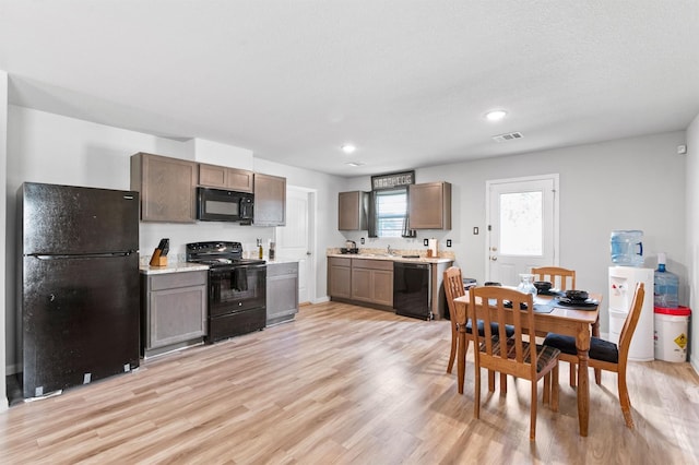 kitchen featuring black appliances and light wood-type flooring