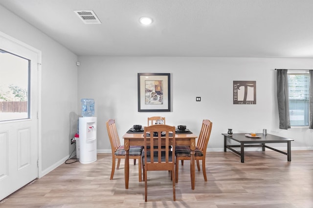 dining space with light hardwood / wood-style flooring