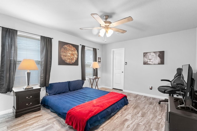 bedroom with ceiling fan and light hardwood / wood-style floors