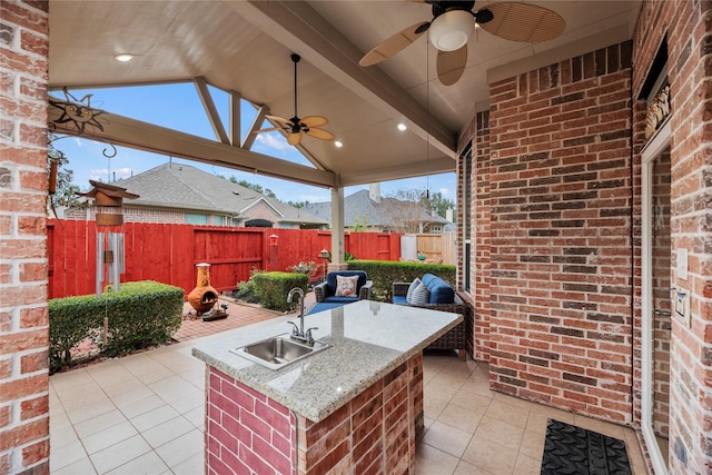 view of patio featuring ceiling fan and a wet bar