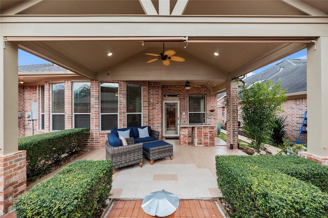 view of patio / terrace featuring a bar, outdoor lounge area, and ceiling fan