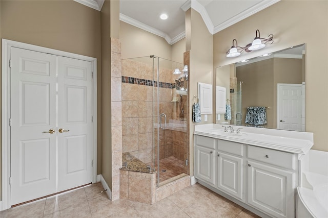 bathroom with tile patterned floors, a shower with door, crown molding, and vanity