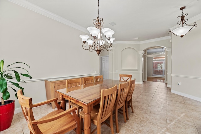 dining room featuring decorative columns, light tile patterned floors, ornamental molding, and a chandelier