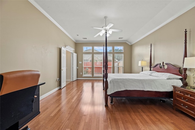 bedroom with ceiling fan, crown molding, light hardwood / wood-style floors, and lofted ceiling