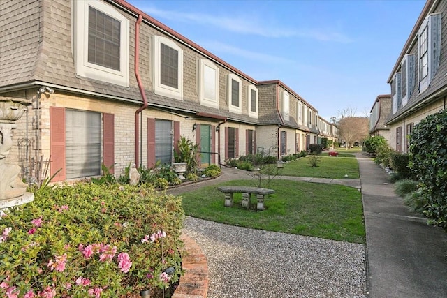 view of home's community featuring a yard