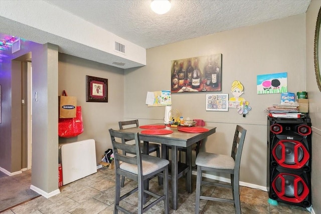 dining room featuring a textured ceiling