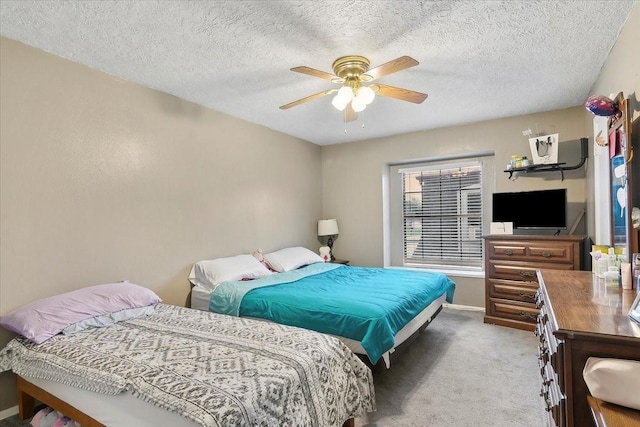 carpeted bedroom featuring a textured ceiling and ceiling fan