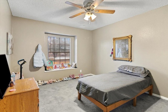 carpeted bedroom with a textured ceiling and ceiling fan