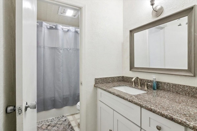 full bathroom featuring toilet, vanity, and shower / bath combination with curtain