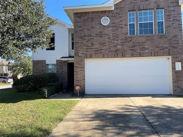 view of front of property with a front yard and a garage