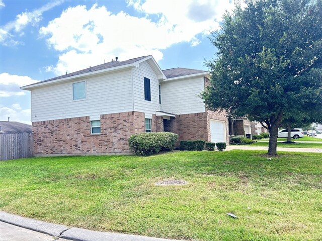 view of side of home with a garage and a lawn