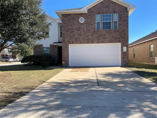 front facade featuring a garage and a front lawn