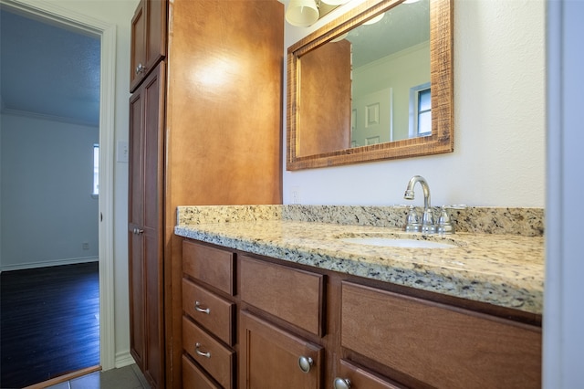 bathroom with vanity and crown molding