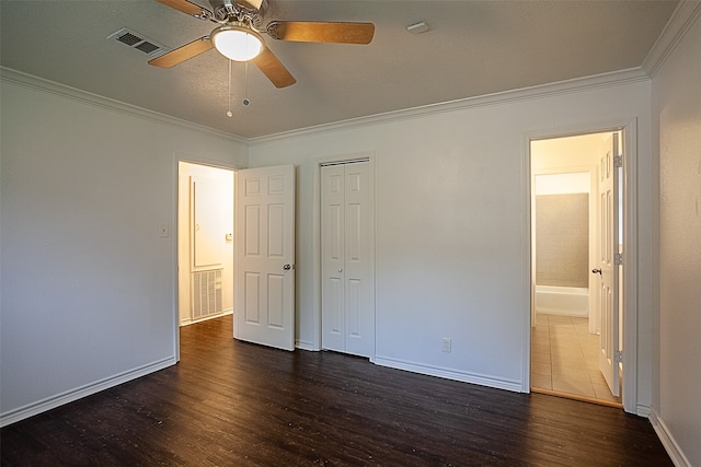 unfurnished bedroom with ceiling fan, a closet, dark hardwood / wood-style flooring, and ornamental molding