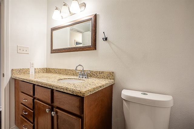 bathroom featuring toilet and vanity