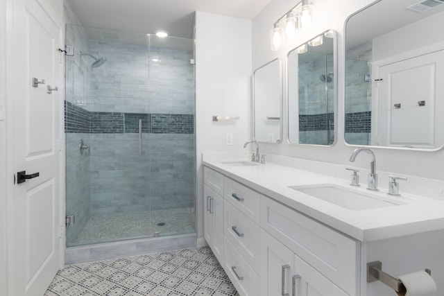 bathroom featuring tile patterned flooring, vanity, and walk in shower