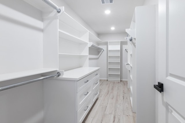 spacious closet with light hardwood / wood-style floors