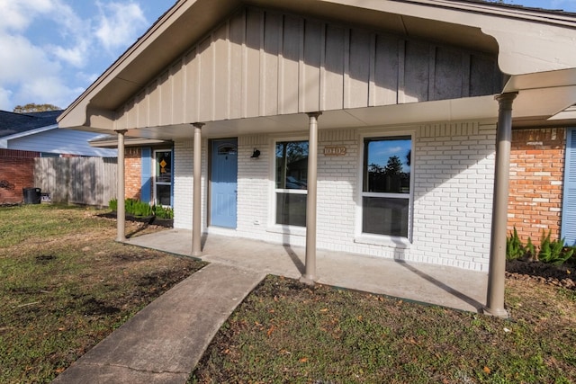 exterior space with covered porch and a lawn