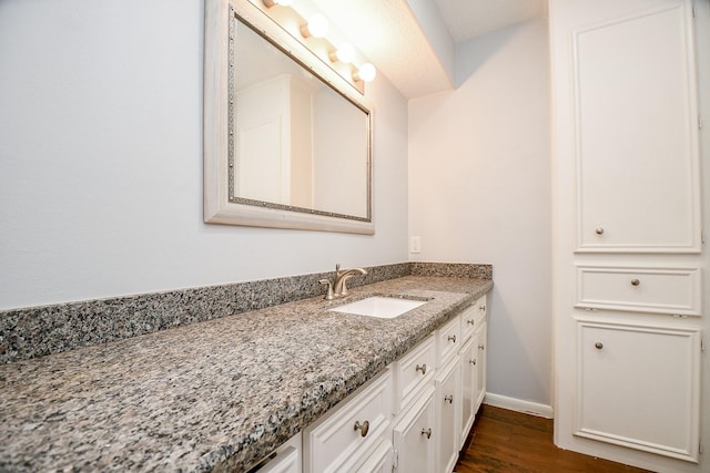 bathroom featuring vanity and wood-type flooring