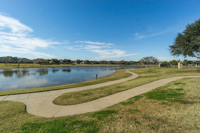 view of community featuring a water view and a yard