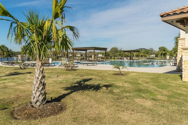 community pool with a yard and a pergola