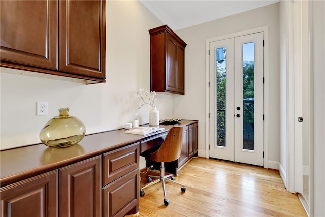 office featuring crown molding, light hardwood / wood-style floors, and french doors