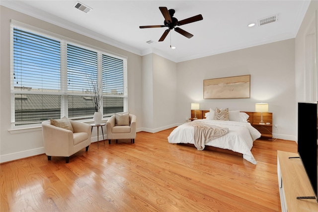 bedroom with light wood-type flooring, ceiling fan, and ornamental molding