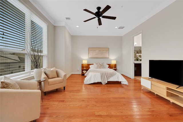 bedroom featuring ceiling fan, ensuite bathroom, light hardwood / wood-style flooring, and ornamental molding