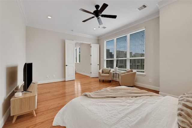 bedroom with ceiling fan, ornamental molding, and light hardwood / wood-style flooring