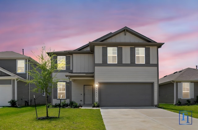 view of front of house with a garage and a yard