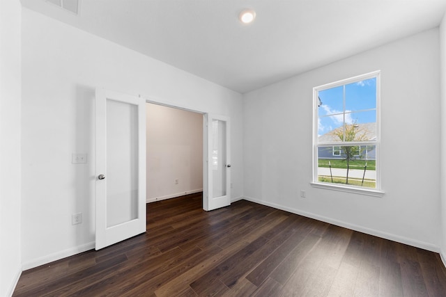 unfurnished bedroom with dark hardwood / wood-style flooring